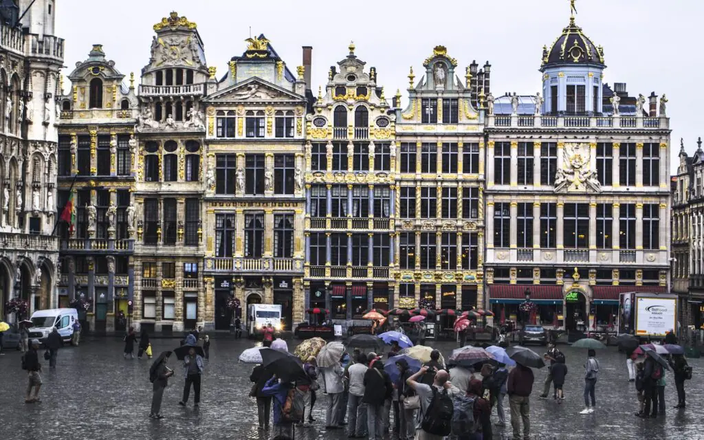 The gilded guildhall facades of the Grand Place in Brussels on a rainy day