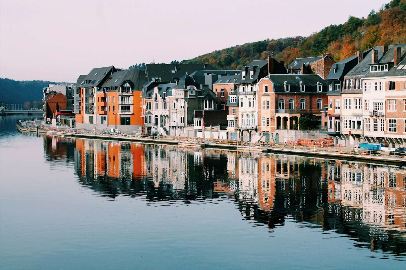 Townhouses along the River Meuse at Dinant, reflected in still water